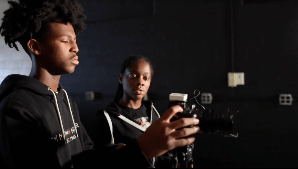 students working a camera